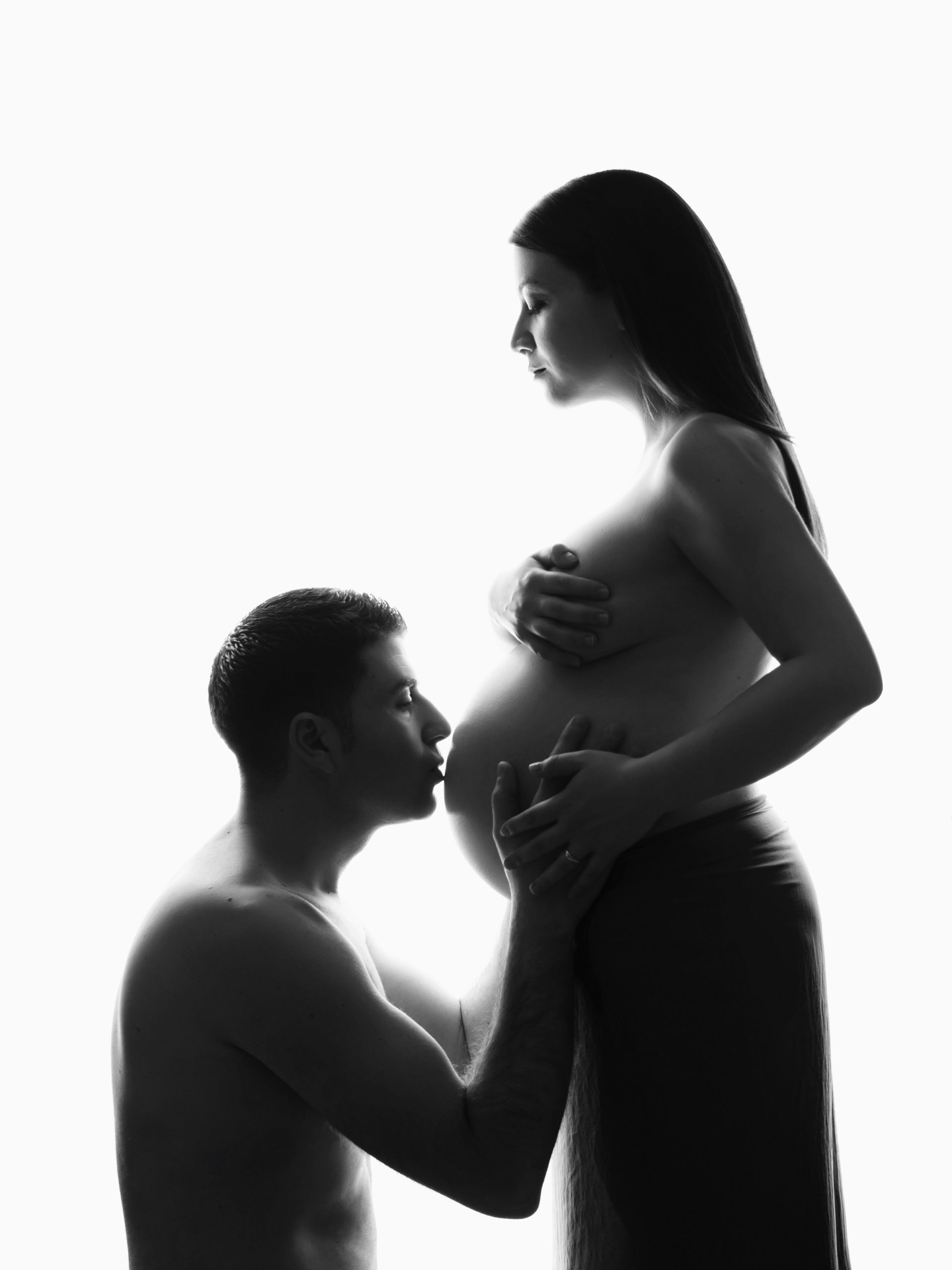 Photo grossesse de silhouette de belle femme enceinte avec future papa réalisée pendent une séance grossesse stylisée avec maquillage et coiffure professionnelles